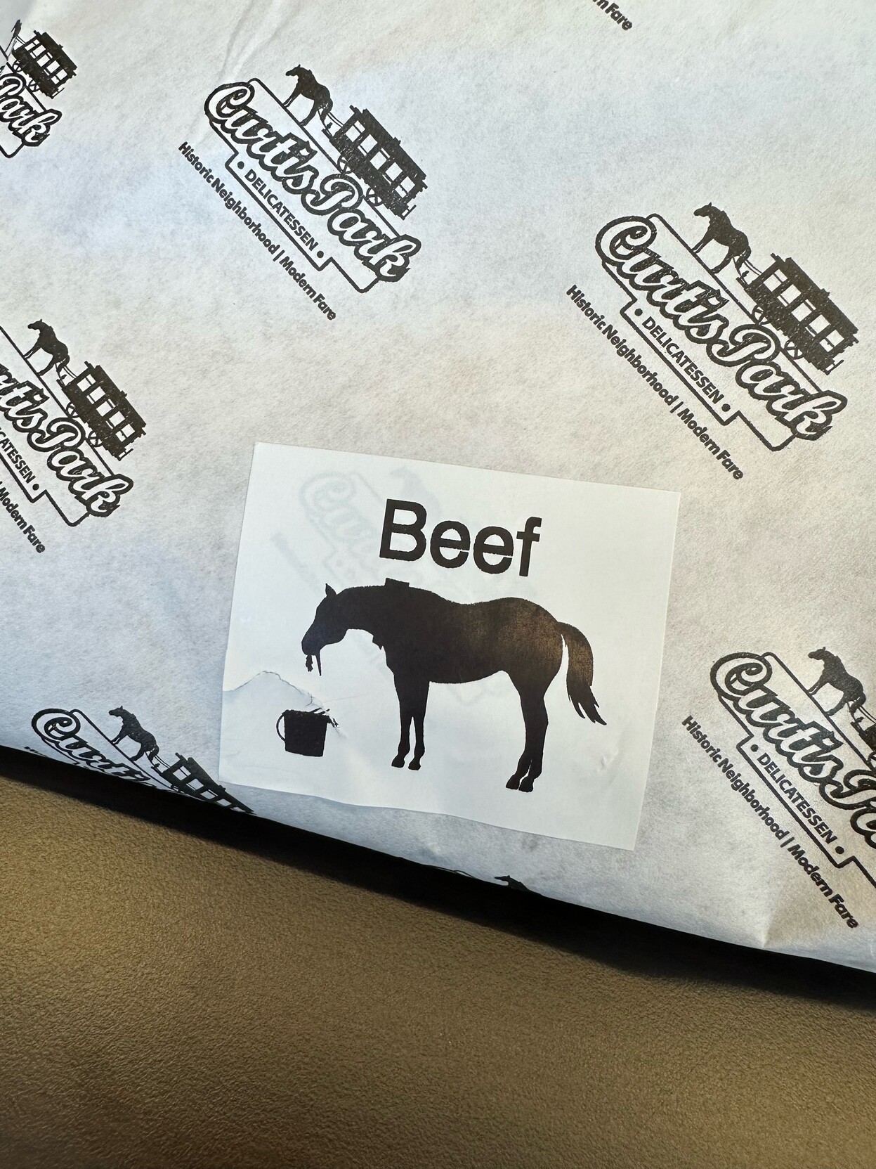 Sandwich wrapping with a label saying “beef” above a drawing of a horse.